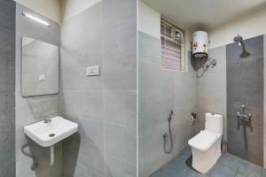a bathroom with a sink and a toilet and a shower at Super Townhouse Marathahalli KLM Fashion Mall Formerly Hotel Avenue in Bengaluru