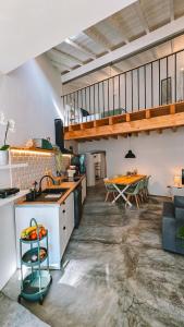 a kitchen with a counter and a table in a room at Casa das Andorinhas-Alentejo in Vidigueira