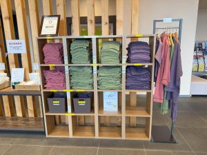 a shelf filled with different colored pillows and clothes at Hotel La'gent Plaza Hakodate Hokuto in Hokuto