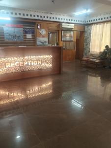 a lobby of a hotel with a reception desk at Home Sweet place in Meerut