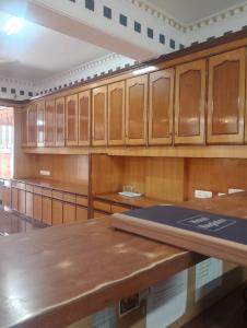 an empty courtroom with wooden cabinets and a table at Home Sweet place in Meerut
