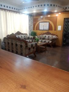 a living room with two couches and a table at Home Sweet place in Meerut