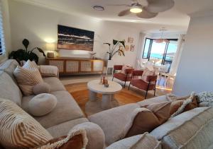 a living room with a couch and a table at Dolce Vista - North Beach Coastal Haven in Perth