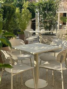 a table and chairs in a patio with a table at La Fermette Champenoise in Jonquery