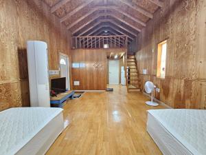 a room with a bed and a desk with a computer at Udo Sunflower Pension in Yŏngil-tong