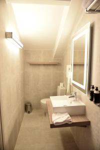 a bathroom with a sink and a toilet and a mirror at Boutique Hotel & Spa la Villa Cap Ferrat in Saint-Jean-Cap-Ferrat