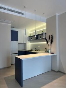 a white kitchen with a counter with a sink at Alvina complex Vakas Tsakghadzor apartament in Tsaghkadzor