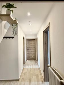 a hallway of a house with a staircase and a door at M&M apartma in Bohinj