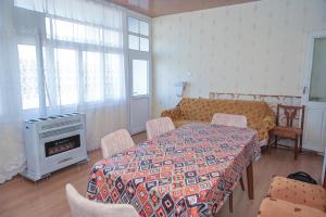a room with a table and a bed and a fireplace at Ilham Mustafa Houses in Sheki