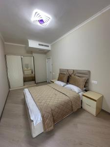 a bedroom with a large bed and a mirror at Alvina complex Vakas Tsakghadzor apartament in Tsaghkadzor