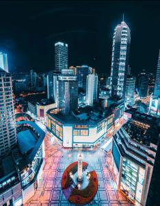 a view of a city skyline at night at Style INS High-Altitude River View Hotel (Chongqing Jiefangbei Pedestrian Street Branch) in Chongqing