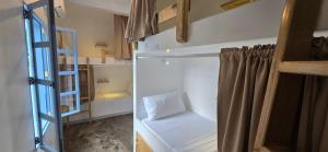 a small room with a bunk bed and a ladder at Blau Hostel in El Nido