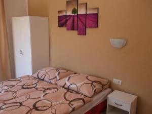 a bedroom with a bed and two paintings on the wall at Ubytovanie Pepo in Štúrovo