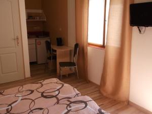 a small room with a table and chairs and a bed at Ubytovanie Pepo in Štúrovo