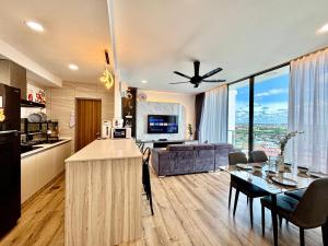 シブにあるHannsLuxury8Pax2KingBedFreeWIfiPoolWasherDryer ComfortStay7のキッチンとテーブルとソファのあるリビングルーム