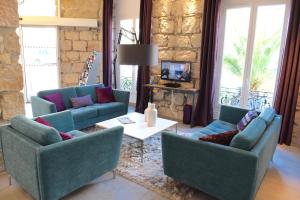 a living room with two couches and a table at Boutique Hotel & Spa la Villa Cap Ferrat in Saint-Jean-Cap-Ferrat