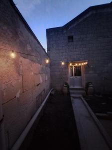 a brick building with a door with lights on it at La Fuitina - Dimora Storica in Cursi