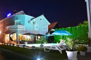 a house with a swimming pool at night at Vila DeLux in Negotin
