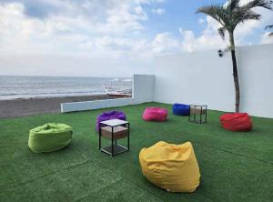 a group of colorful bean bags on the beach at Palm Rose Beach Resort in Nasugbu