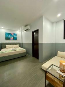 a room with two beds and a table in it at Palm Rose Beach Resort in Nasugbu +3 photos