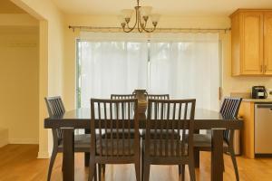 a dining room table and chairs in a kitchen at Malibu Sage & Sea Sanctuary in Malibu
