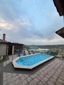 a swimming pool with chairs and a view of a river at Torre Belvedere in Nuévalos