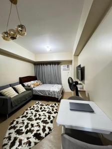 a living room with a bed and a couch at City Proper Avida Towers in Cagayan de Oro
