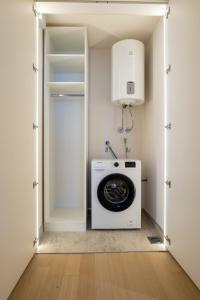 a laundry room with a washer and dryer at Zepterme Spa&Wellness Luxury Apartments member of Zepter hotels in Vrnjačka Banja