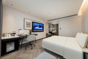 TV a/nebo společenská místnost v ubytování Atour Hotel Zhengzhou Provincial Museum Dongfeng Road