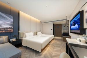 Postel nebo postele na pokoji v ubytování Atour Hotel Zhengzhou Provincial Museum Dongfeng Road