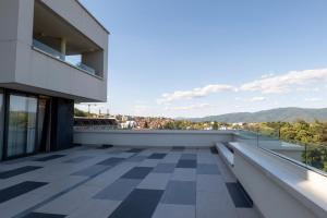 a balcony with a view of the mountains at Zepterme Spa&Wellness Luxury Apartments member of Zepter hotels in Vrnjačka Banja