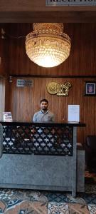 a man standing behind a counter in a restaurant at RKs Regency in Pune