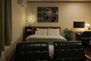 a bedroom with a bed and a desk with a computer at Anook Hotel Jeonju in Jeonju