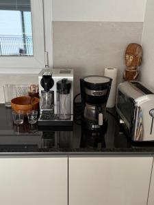a kitchen counter with a coffee maker and a coffeemaker at Chambre chez l'habitant in Saxon