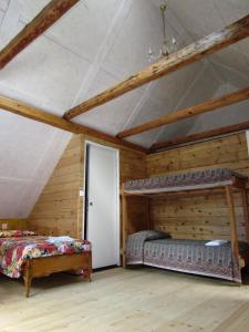 a bedroom with two beds and a white door at Joe's Place in Log pod Mangartom