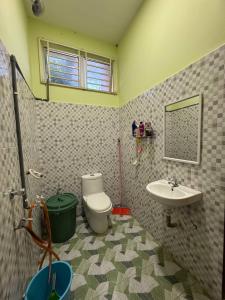 a bathroom with a toilet and a sink at HB Warisan Homestay in Kota Bharu
