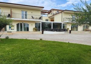 a large house with a large yard in front of it at Esperidi Paestum Agri Resort in Capaccio-Paestum