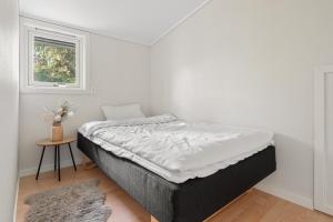 a bed in a room with a window at Tromsø Terrace - Top floor apartment with amazing views in Tromsø