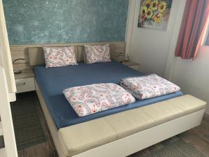 a bed with two pillows on it in a room at Sea View Holiday for Family and Friends Aheloy, near Sunny Beach-Почивка с изглед към морето за семейство и приятели Ахелой, близо до Слънчев бряг in Aheloy +94 photos