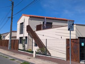 a house with a staircase on the side of it at Pré Madame, Terrasse, Parking in Riom