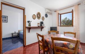 a dining room with a table and chairs and a window at Apartman Milka in Stinica