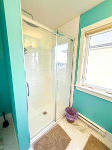 a glass shower in a bathroom with a window at Your Halifax Getaway, Relax and Explore in Halifax +16 photos