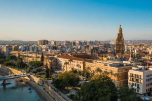 a view of a city with a clock tower and a river at Apartamento - 2HAB - 4PAX - Platería - Murcia in Murcia