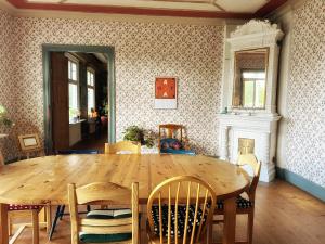 a dining room with a wooden table and chairs at Villa Calcar in Södertälje