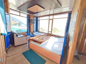 a bedroom with a bed and a window at Hotel Pandey Lodge By StayApart in Munsyari