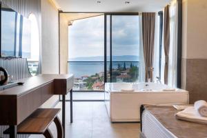 a bathroom with a tub and a large window at Sapanora Hotel in Sapanca