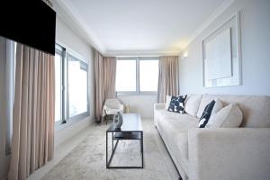a living room with a couch and a table at Orchid Hotel by HolyGuest in Tel Aviv
