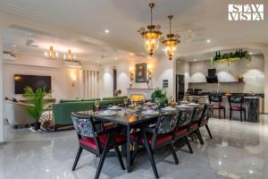 a dining room with a table and chairs at StayVista at Solace Land with Bonfire, Jacuzzi in Lonavala