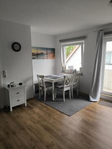a dining room with a table and chairs at Ostseewohnung Weiße Wiek in Hohenkirchen