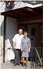 a man and a woman standing outside of a building at Landgasthof zur Post in Heiligenberg